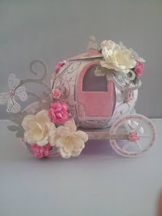 a pink and white carriage with flowers on it