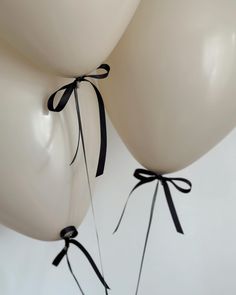 two white balloons tied to each other