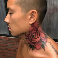 a man with a flower tattoo on his neck