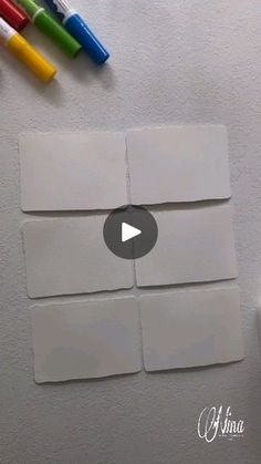 the video shows how to make an origami note board with markers and crayons