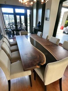 a large wooden table surrounded by beige chairs