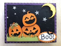 a halloween card with two pumpkins and a moon