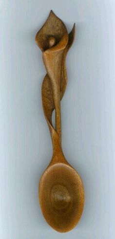 a wooden spoon with two people on it