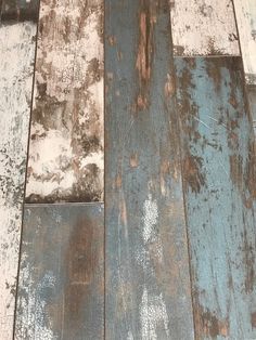 an old wood floor with peeling paint and chipping on the top part of it