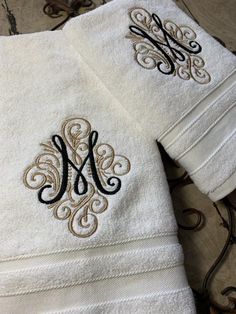 two towels with monogrammed letters on them