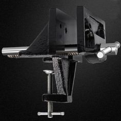 a black and white photo of a computer monitor on a metal stand with screws