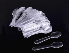 plastic spoons and forks on a black surface