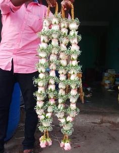 a man is holding a bunch of flowers