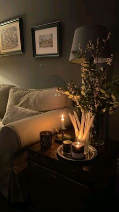 a living room filled with furniture and candles