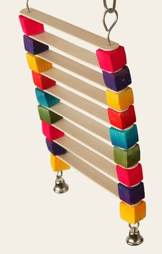 a multicolored wooden wind chime hanging from a metal hook