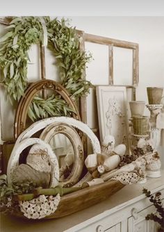 a shelf filled with lots of assorted items on top of a white dresser next to a mirror