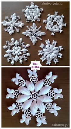 some white paper snowflakes on top of a wooden table next to each other