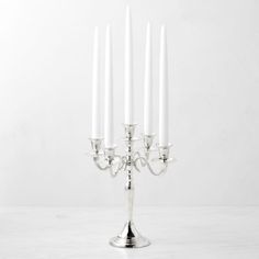 Illuminate the table with our dazzling candelabra. Designed to emulate the dramatic beauty of a vintage find, it's crafted of brass with an electroplated silver finish that's hand polished to a high shine. The showstopping piece holds five taper candles (sold separately). Holds five taper candles (sold separately). Crafted of brass with electroplated silver finish. Hand polished to a high shine. Felted base protects surfaces from scratches. Hosting Decor, Entertaining Table Settings, Silver Candelabra, Holiday Hosting, Entertainment Table, Table Setting Inspiration, Fall Cocktails, Organization Furniture, Tiered Stand