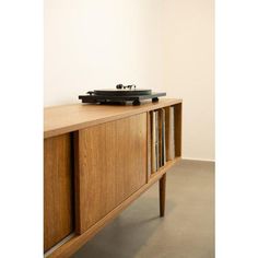 a record player sitting on top of a wooden cabinet