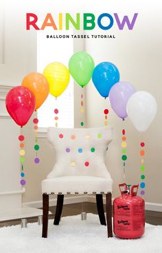 the balloon table is set up in front of a chair with balloons attached to it