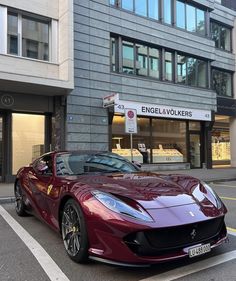 a red sports car parked in front of a building