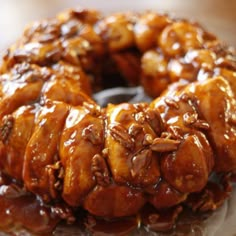 a bundt cake covered in caramel and pecans