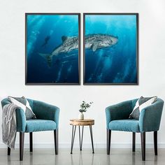 two chairs in front of a wall with shark pictures on it and a table next to them