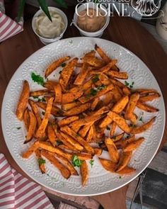 a white plate topped with cooked carrots on top of a wooden table