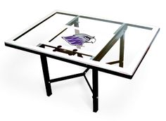 a glass table with metal legs and a white top that has the words climate on it