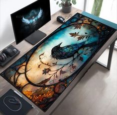 a computer desk with a painting on it