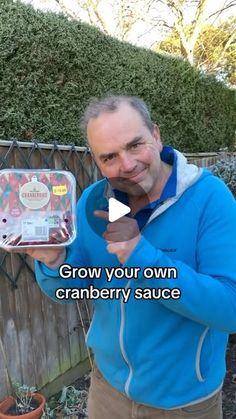 a man holding up a container with cranberry sauce in it and pointing to the camera