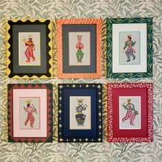 four framed pictures on a wall with different colors and designs, each depicting an individual's artwork