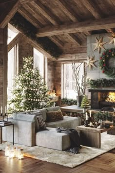 a living room filled with furniture and a fire place next to a christmas decorated tree