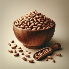 a wooden bowl filled with nuts next to a scoop