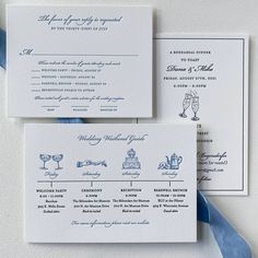 the wedding stationery is laid out on top of each other, with blue ribbon