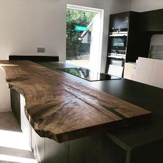 a large wooden counter top sitting inside of a kitchen