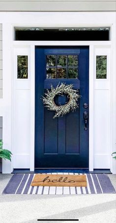 a blue front door with a wreath on it