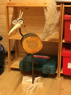 an odd looking bird sitting on top of a wooden table