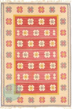 a red and yellow rug with an intricate design on the bottom, in front of a white background