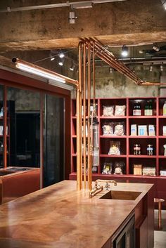 a kitchen with red shelving and wooden counter tops