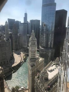 an aerial view of a city with tall buildings and a river in the foreground