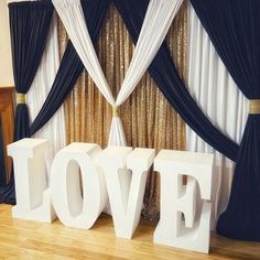 the word love spelled out in front of curtains