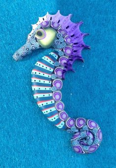 a purple sea horse laying on top of blue carpet