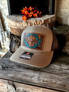 Mid trucker hat with one of a kind tooled leather patch. Patch features scroll work and Aztec. Hat is SnapBack adjustable and is khaki tan and coffee brown in color. PLEASE READ: This item is for pre-ordering, and is made to order! Once purchased, this item will take approximately two weeks to re-create. Item will be a close replica, but each one will have slight variances in color, carving, etc. as I am not perfect, and leather is not perfect either! Western Style Brown Flat Bill Baseball Cap, Western Brown Trucker Hat With Flat Bill, Western Style Brown Trucker Hat With Flat Bill, Western Style Brown Snapback Hat For Rodeo, Western Style Baseball Cap With Short Brim, Western Style Snapback Hat With Short Brim, Western Brown Snapback Hat With Flat Bill, Brown Western Style Baseball Cap, Western Brown Snapback Hat