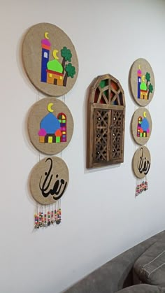 the wall is decorated with wooden circles and arabic writing on them, along with hanging decorations