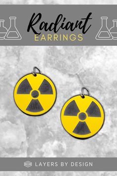 two yellow and black radioactive earrings with the words radiat earings on them