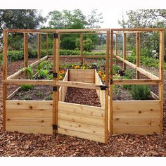 a wooden garden box with plants growing in it