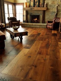 a living room filled with furniture and a fire place in the middle of it's walls