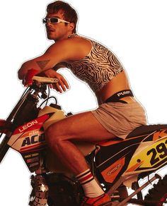 a man riding on the back of an orange and black dirt bike with no helmet