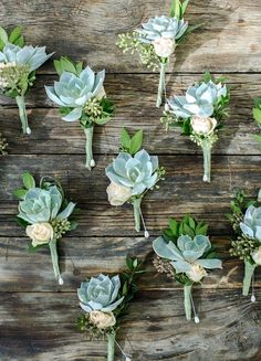 wedding flowers laid out on wooden planks for the bride's boutonnieres