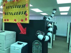 an office cubicle decorated for halloween with creepy decorations and signs on the walls,