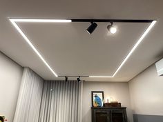 an empty room with some lights on the ceiling