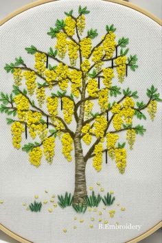 a cross stitch tree with yellow flowers on it