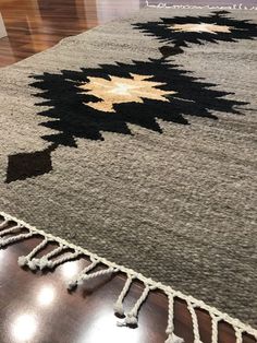 an area rug with black and white designs on it