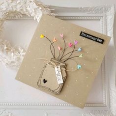 a card with a mason jar filled with paper hearts and some string attached to it